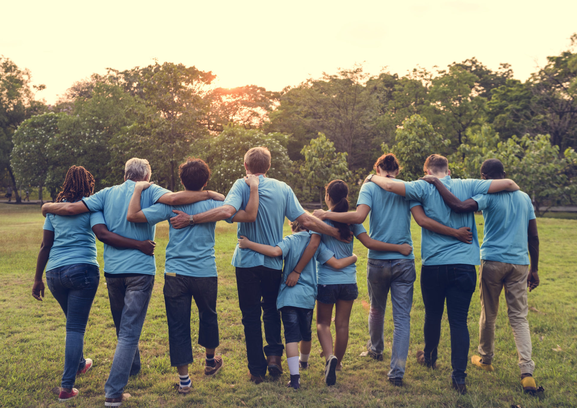 group of people with arms around each other