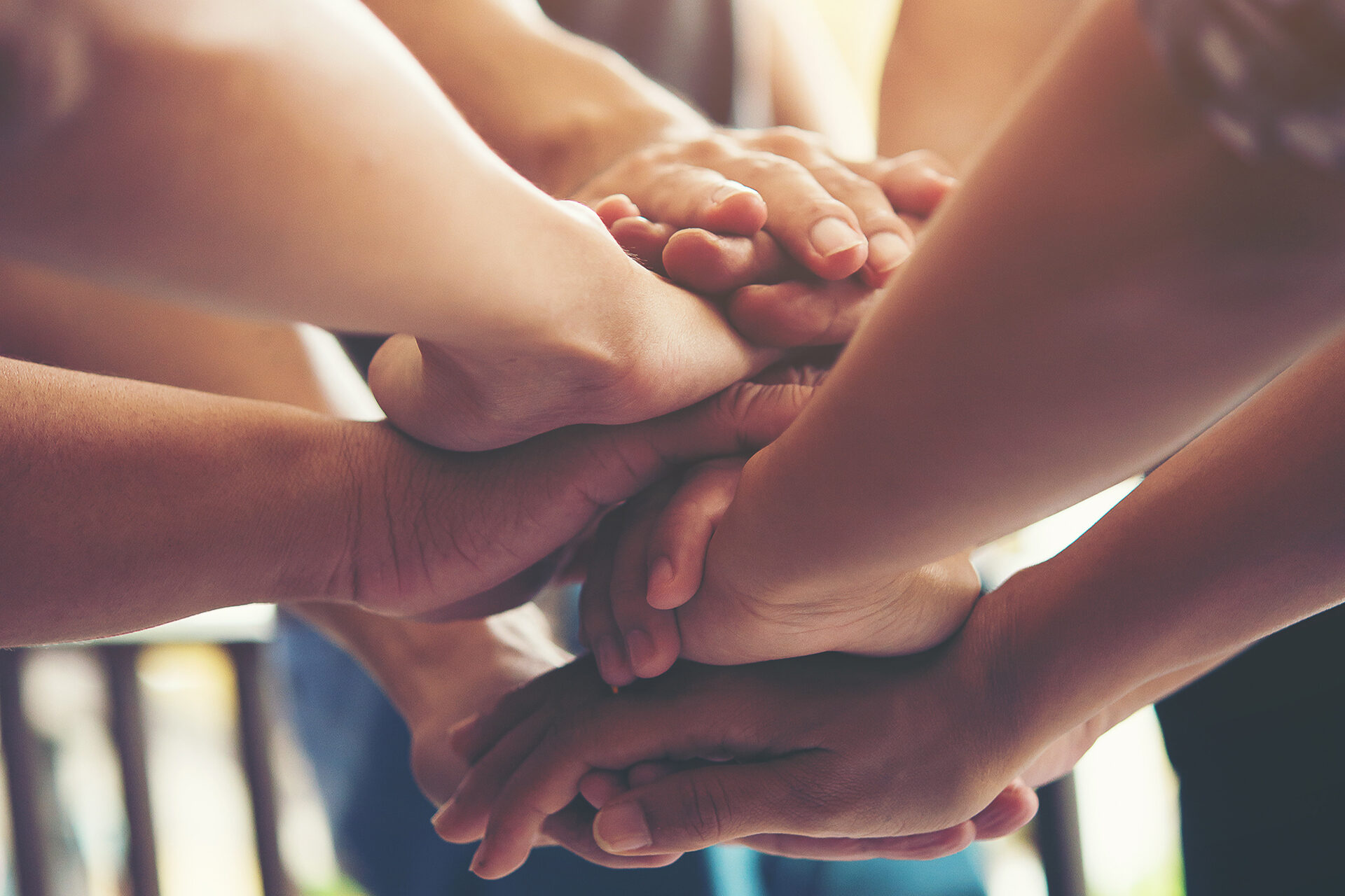 Group of People putting hands together in huddle