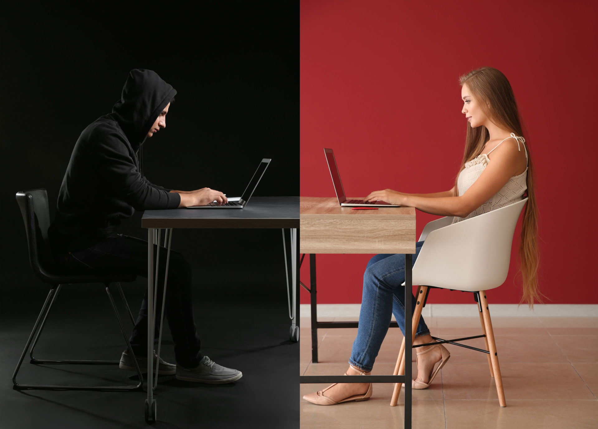 a girl and a computer hacker sitting across from each other at a desk.