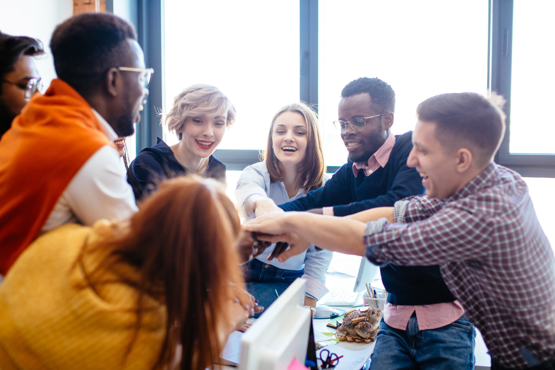 employees putting hands in circle