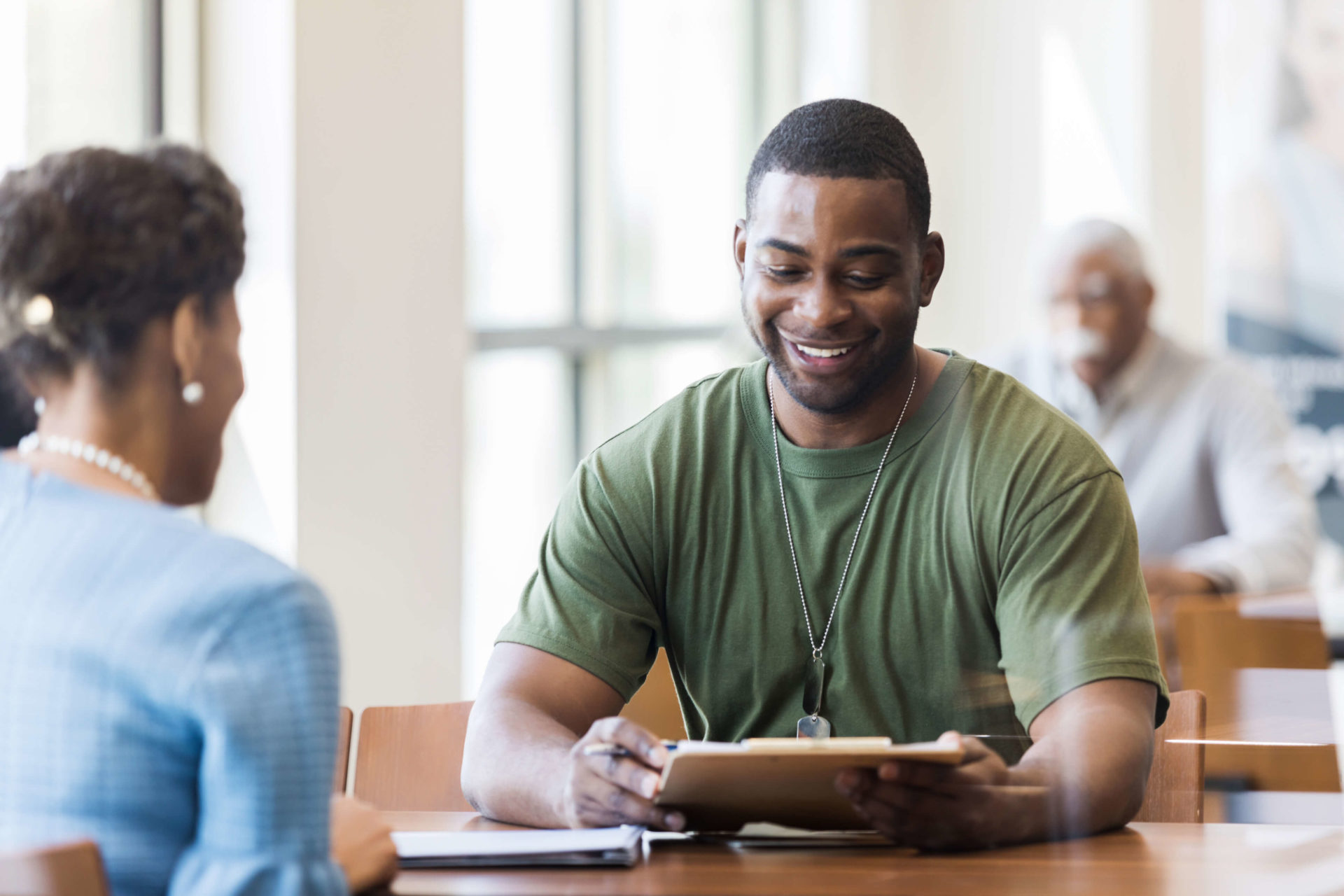 guy smiling looking at paperwork
