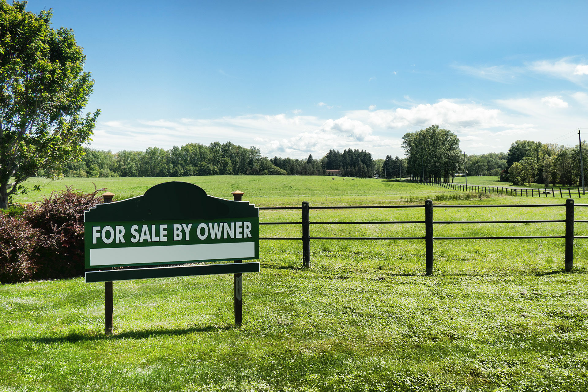for sale by owner sign on a large lot of land